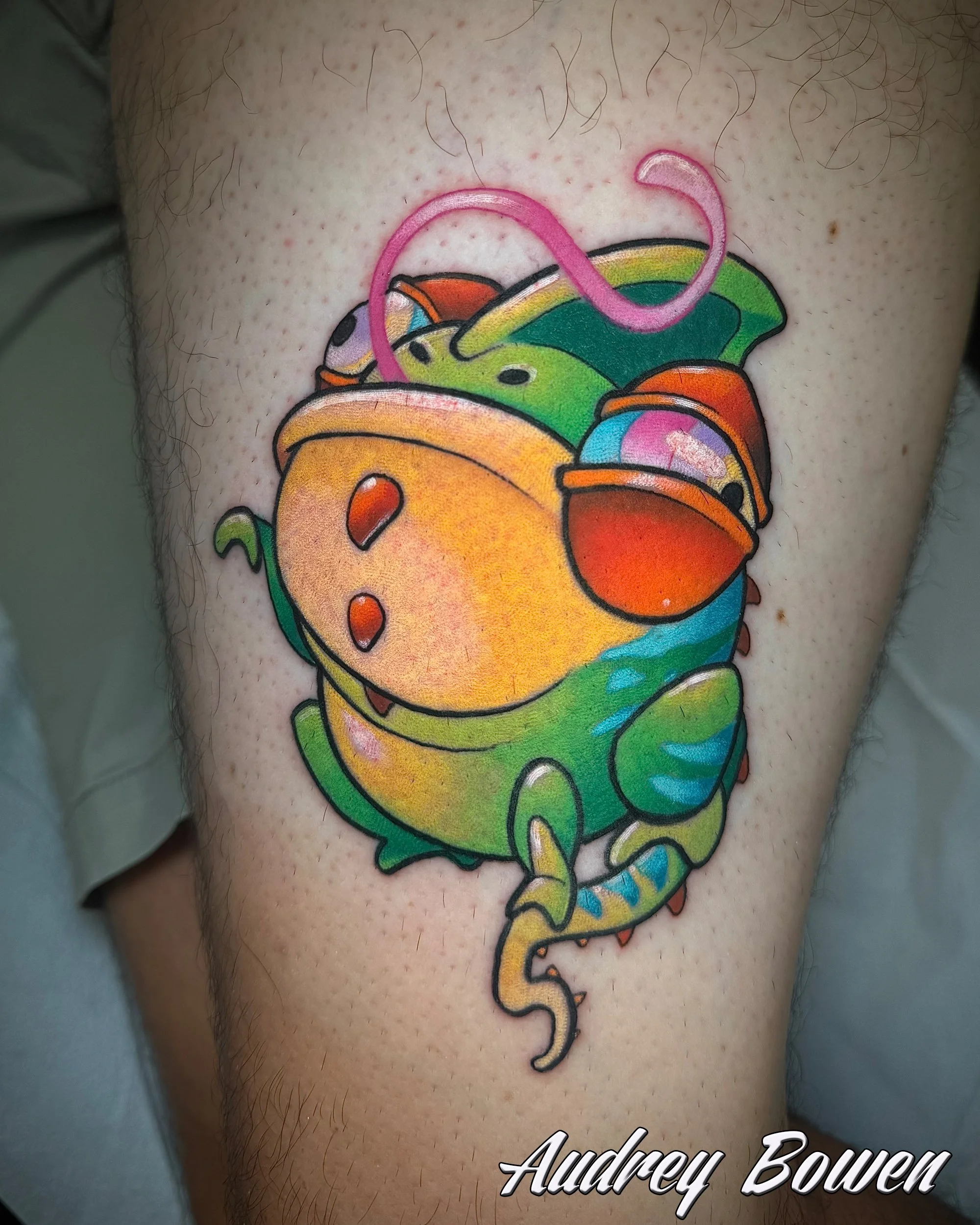 Colorful tattoo of a frog on a person's arm. Tattoo by Audrey Bowen, Karmic Tattoo, Clearwater Florida
