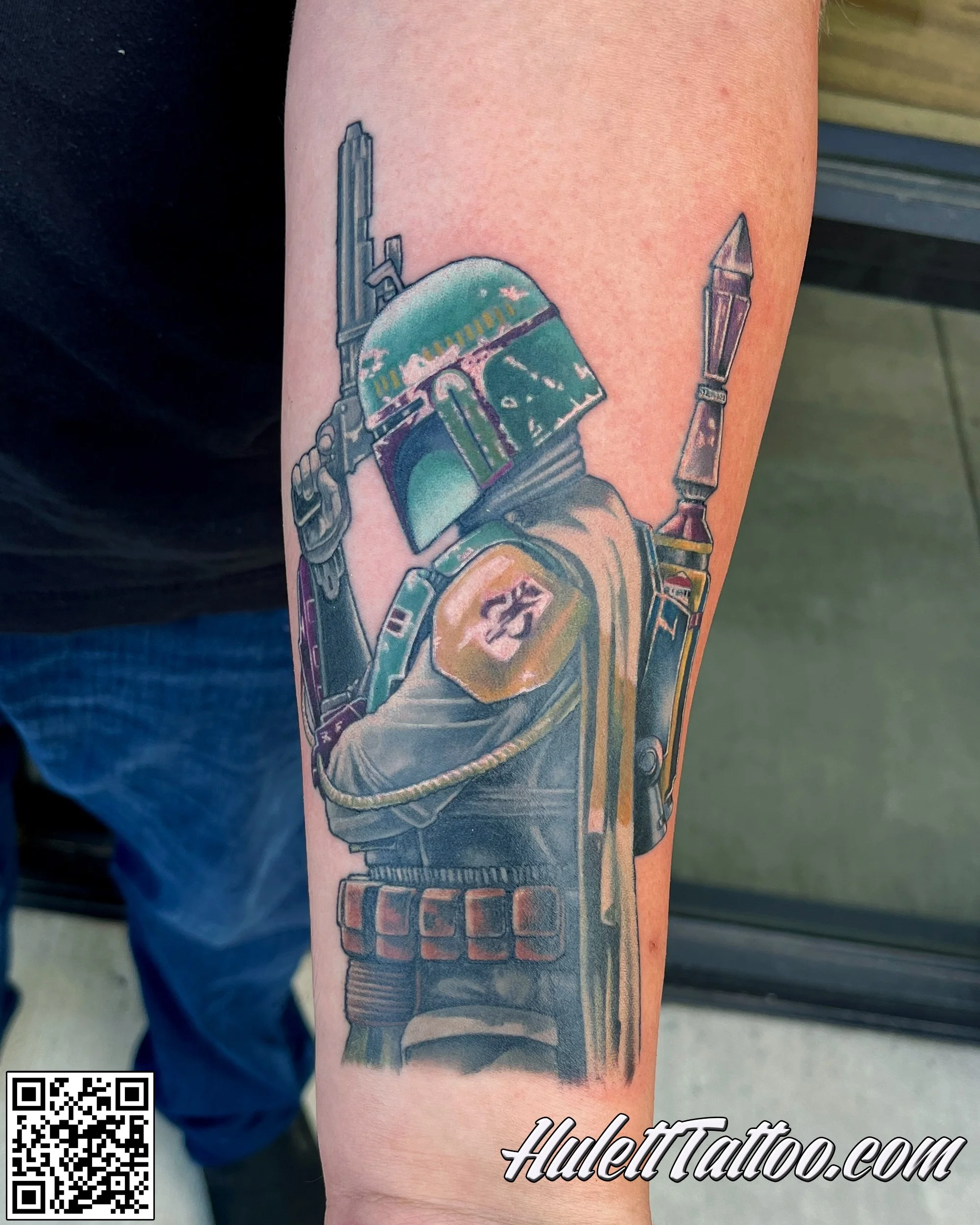 A tattoo of Star Wars character Boba Fett on a person's arm.
