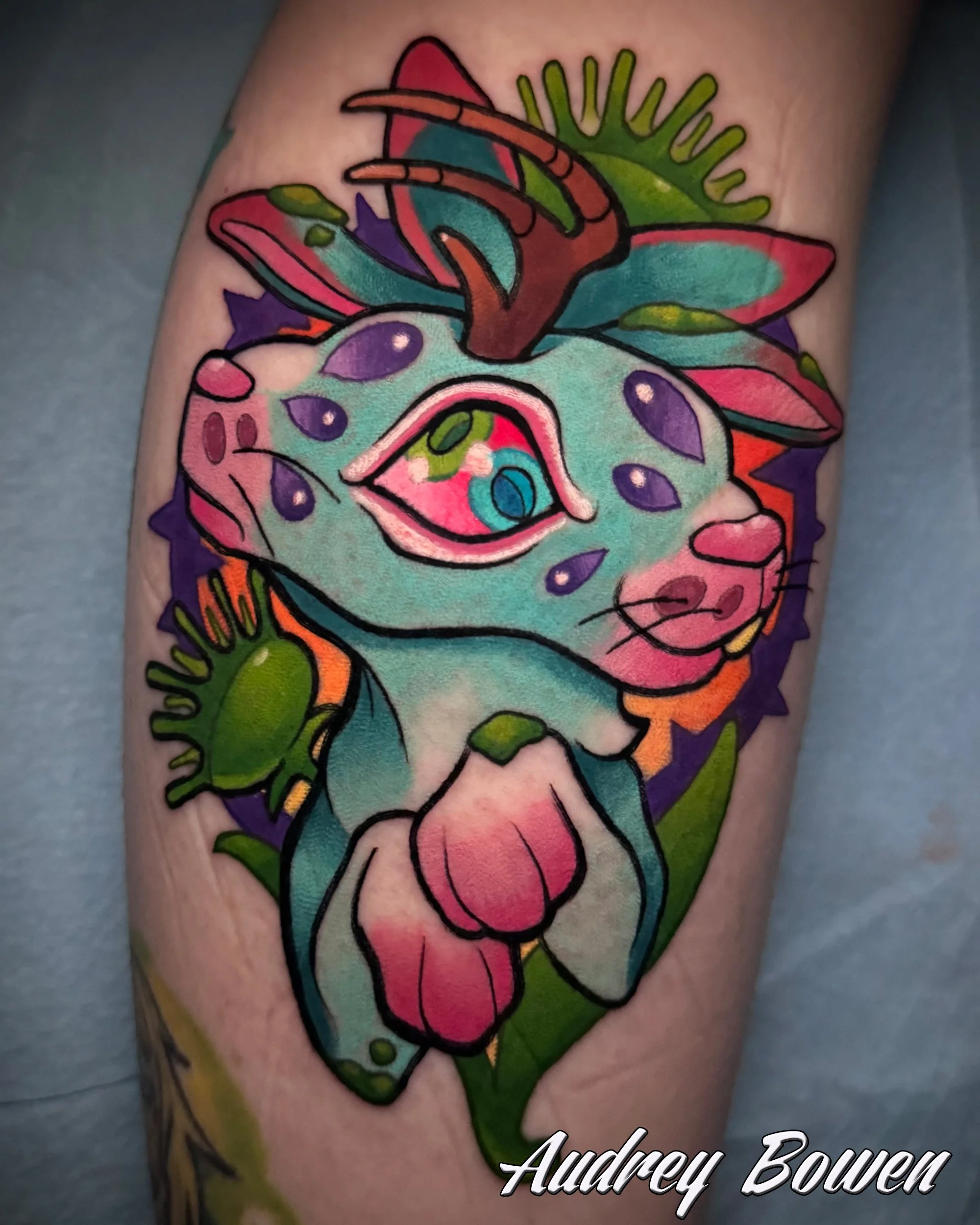Colorful tattoo of a siamese jackalope with abstract designs and vibrant colors. Tattoo by Audrey Bowen, Karmic Tattoo, Clearwater Florida