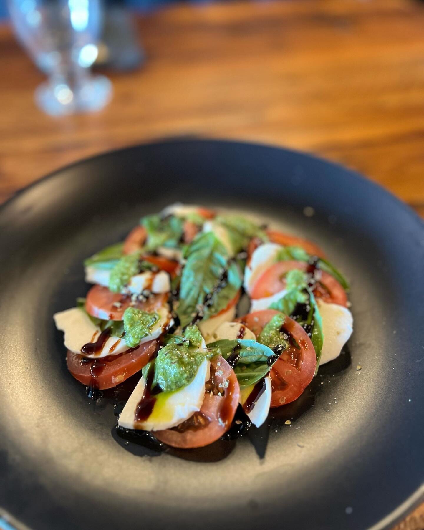 Experience the perfection of our exquisite caprese salad paired with a fine glass of wine.🍷🥗. #corkitkaty #winelover #winetasting