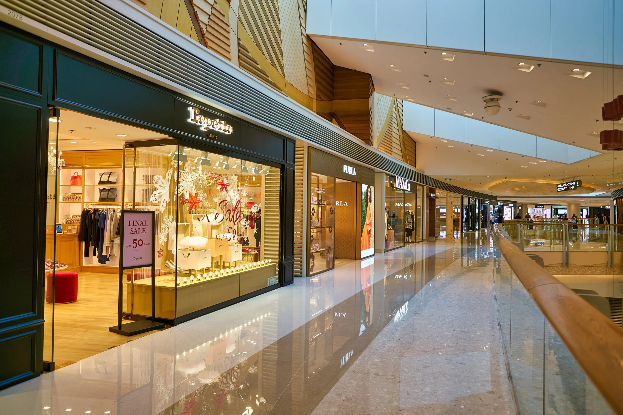 Large format print of a modern shopping mall interior with luxury retail storefronts, glass displays, and polished floors, ideal for retail branding and commercial interior design.