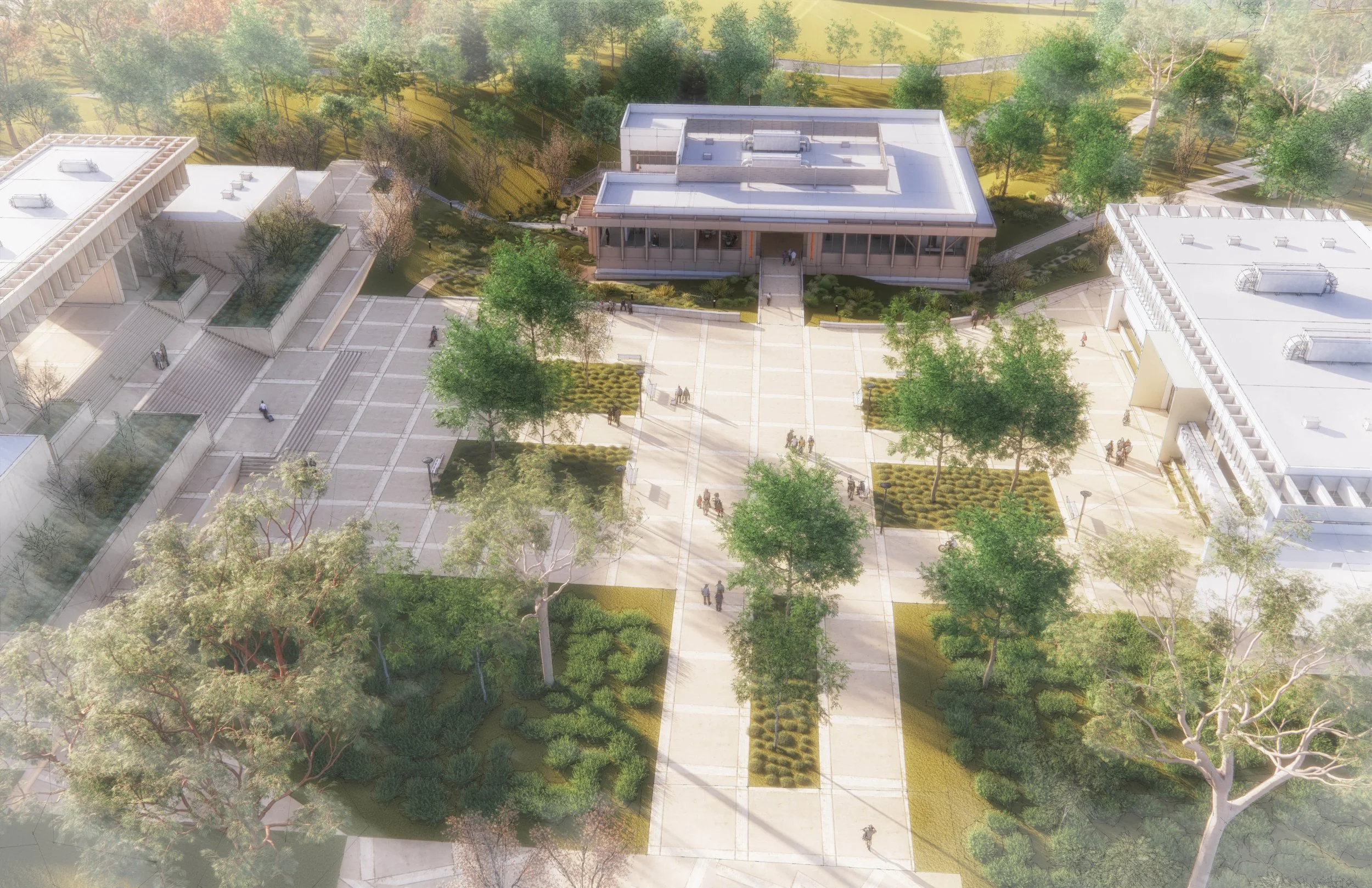 Aerial view of a university campus courtyard with two buildings on the sides, pathways, and landscaped green areas with trees and bushes. Students walk across the plaza.