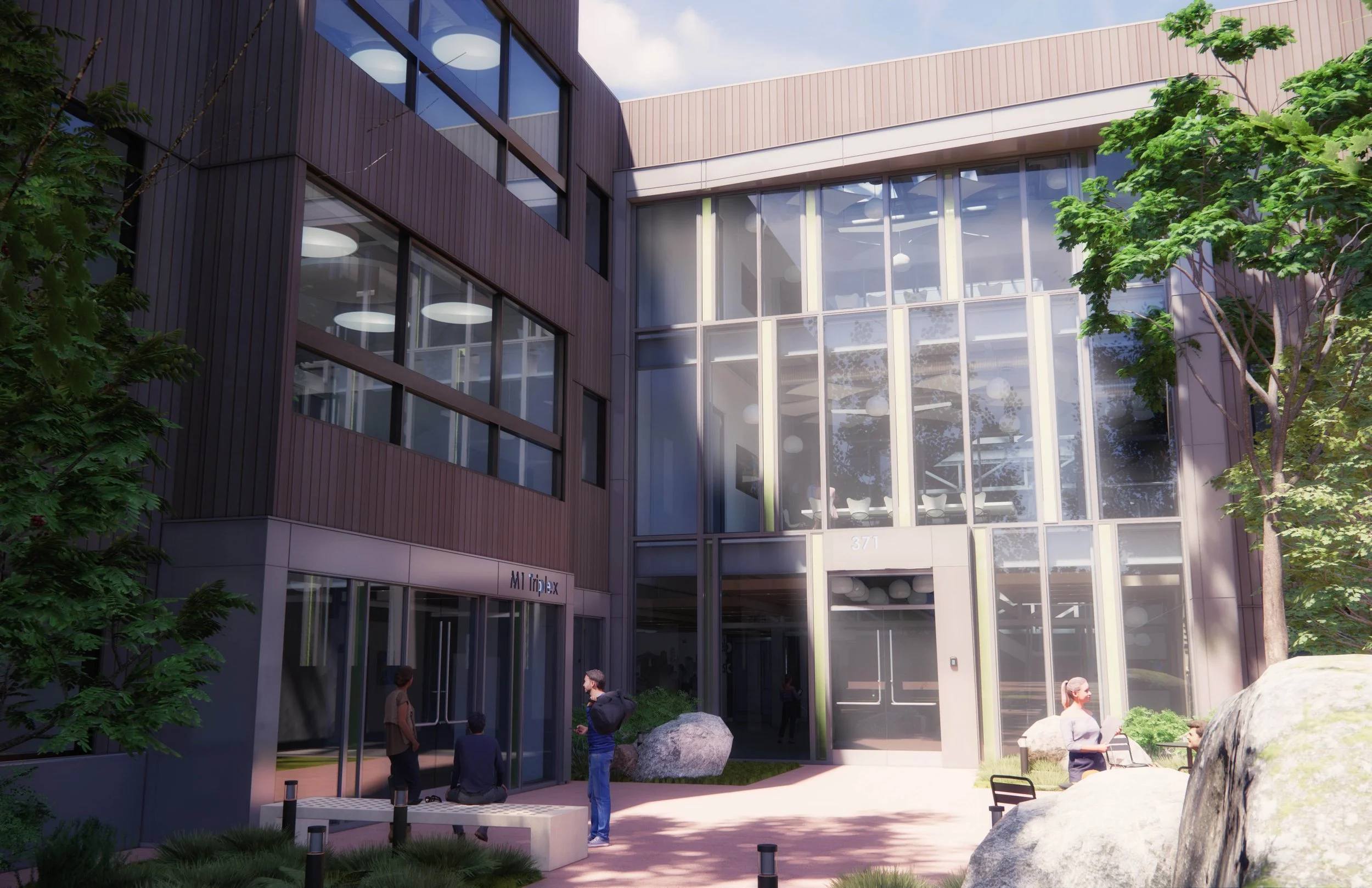 Modern office building with large glass windows and wooden exterior, surrounded by trees and rocks, with people outside.