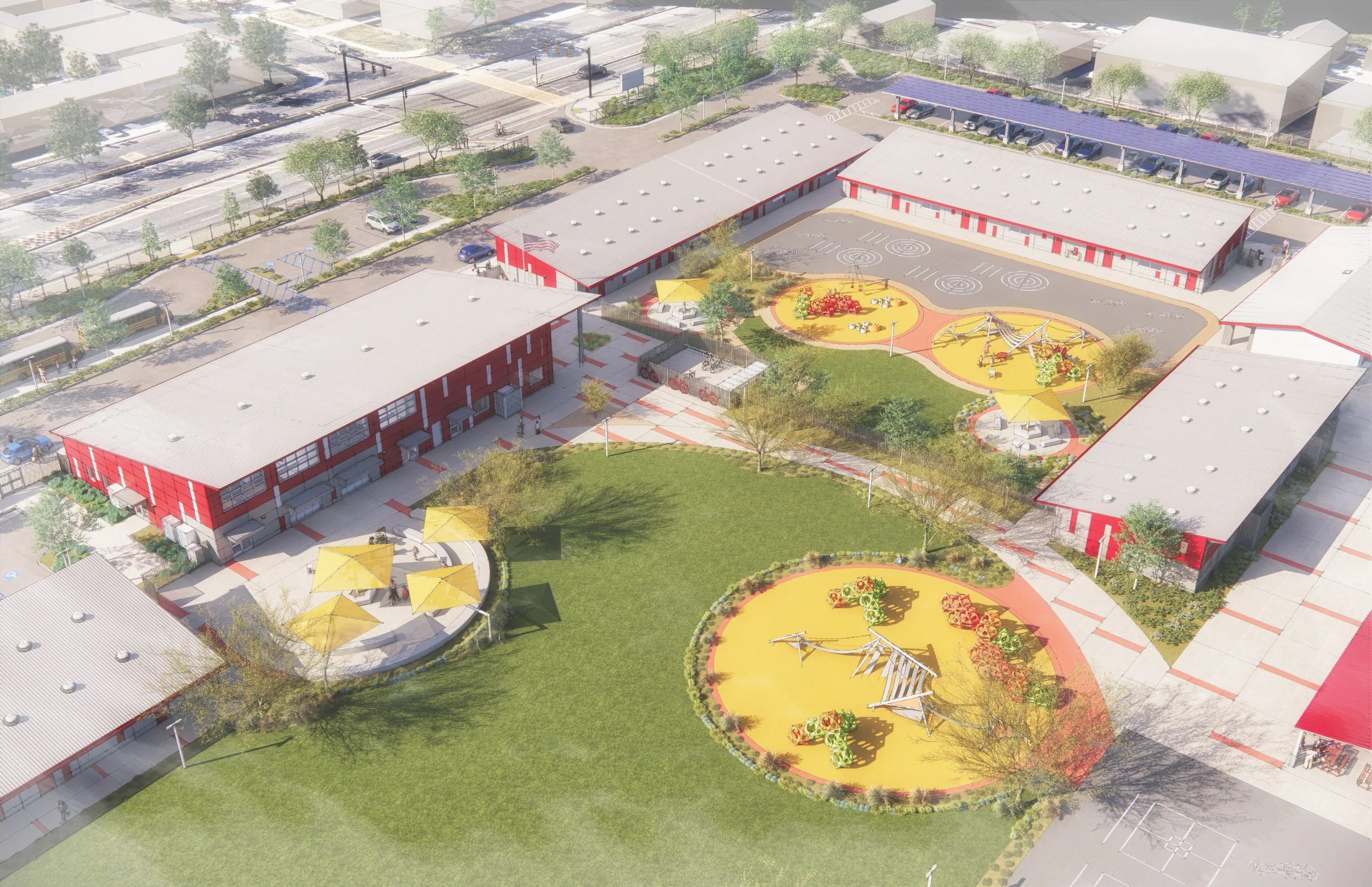 A school campus with multiple red buildings, a playground with yellow safety surfaces, swings, a slide, and shaded seating areas with yellow umbrellas, surrounded by green lawns and trees, with parking lots and roads nearby.