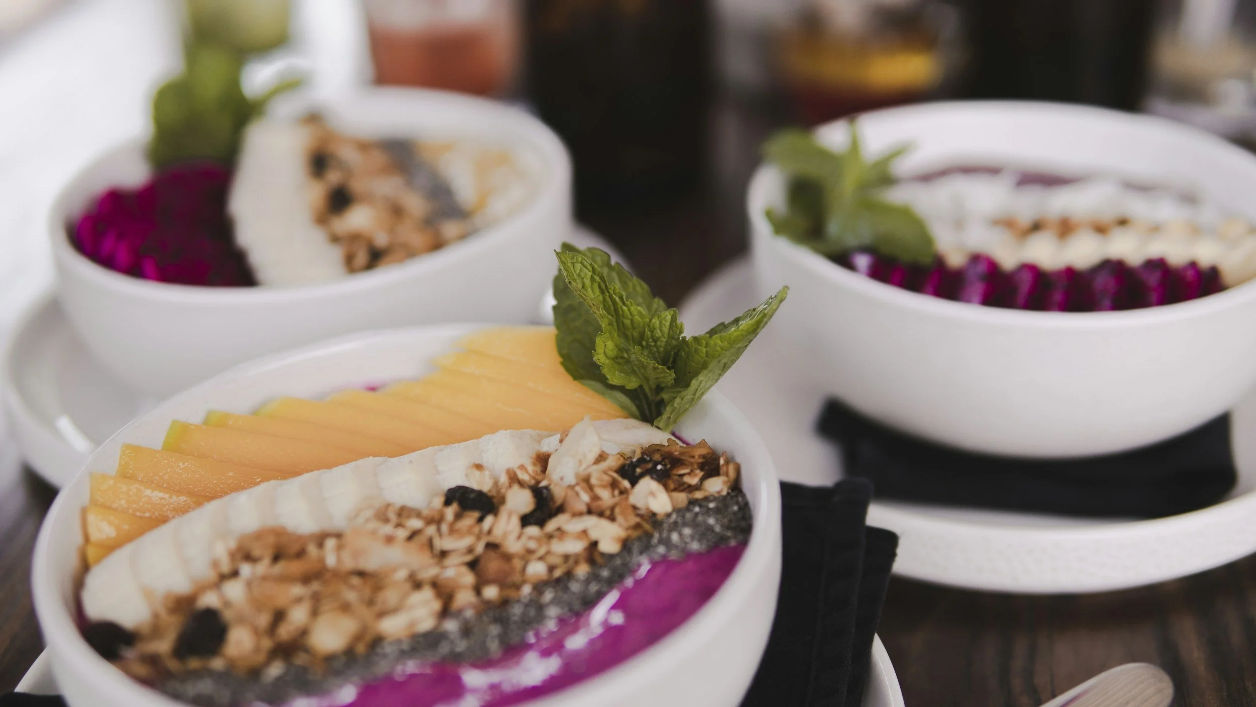 Whole-food plant-based smoothie bowls topped with fruit and low-fat granola.