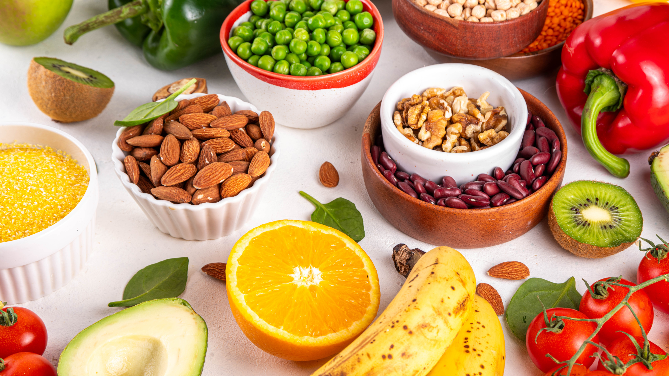 A spread of foods included on the portfolio diet -- fresh fruits, vegetables, legumes, nuts, and whole grains.
