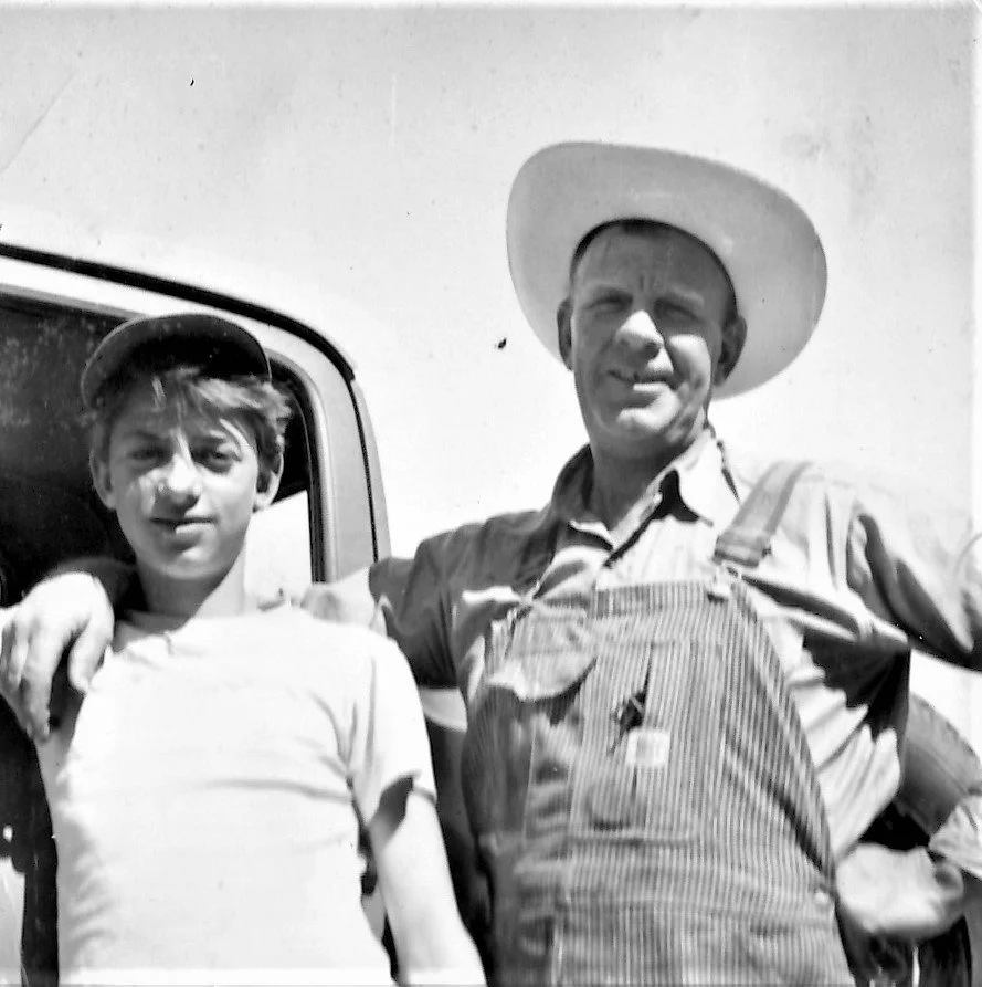 Henry and Richard Schmidt standing next to a truck.