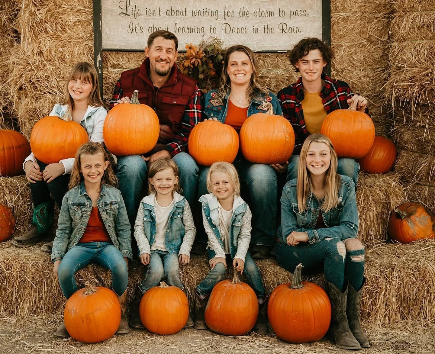 Ryan Schmidt, Anna Schmidt, and their six children celebrating fall with a pumpkin patch photo shoot.