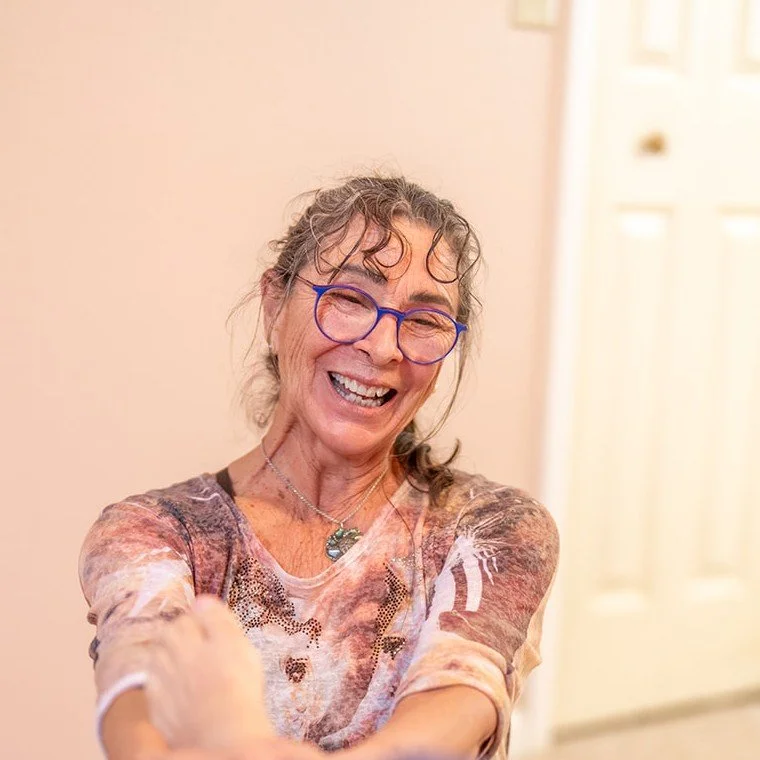 Kyra Russell laughing in her massage room in Cullowhee, NC