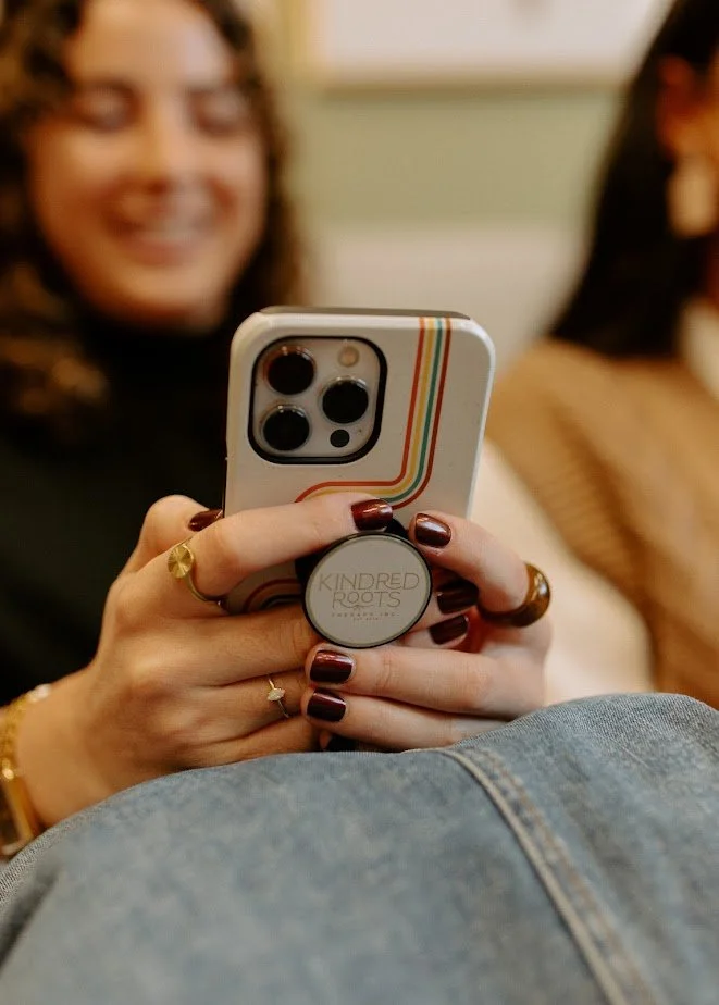 person smiling at phone