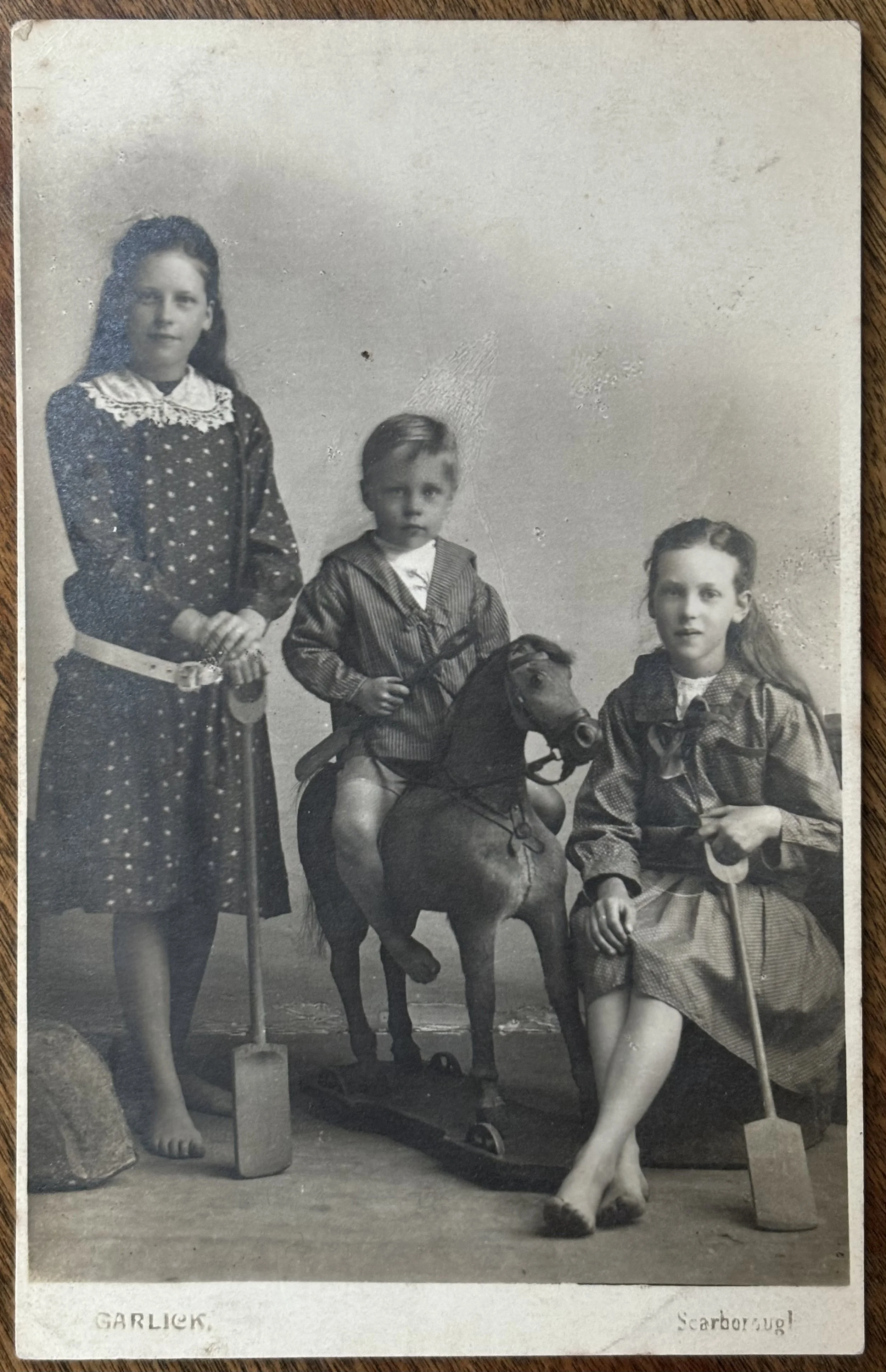 Portrait of three children with a toy horse and spades, by Walter Garlick Photographer from Scarborough