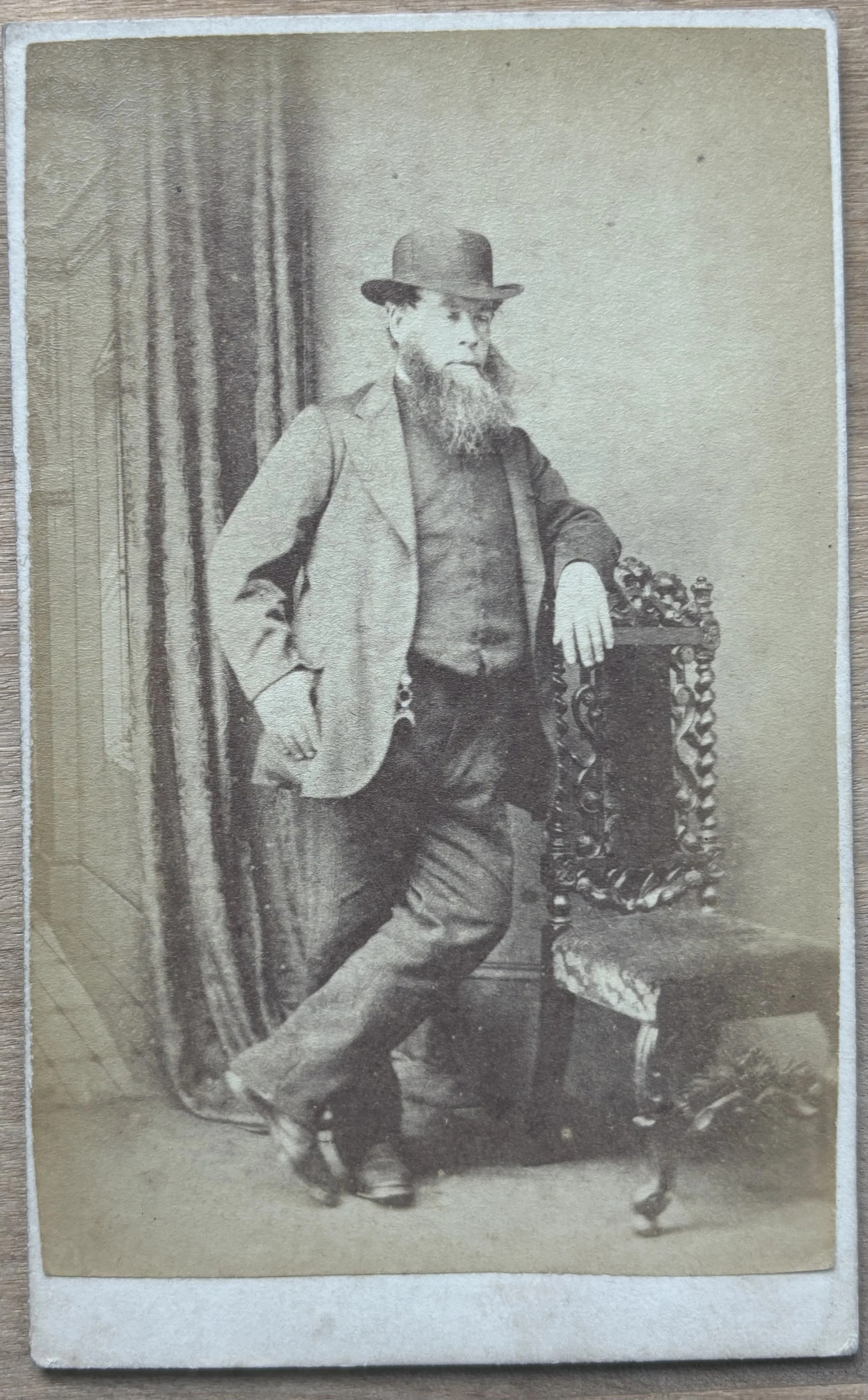 Unknown man in a bowler hat leaning against a chair, by R. Storer, Scarborough photographer