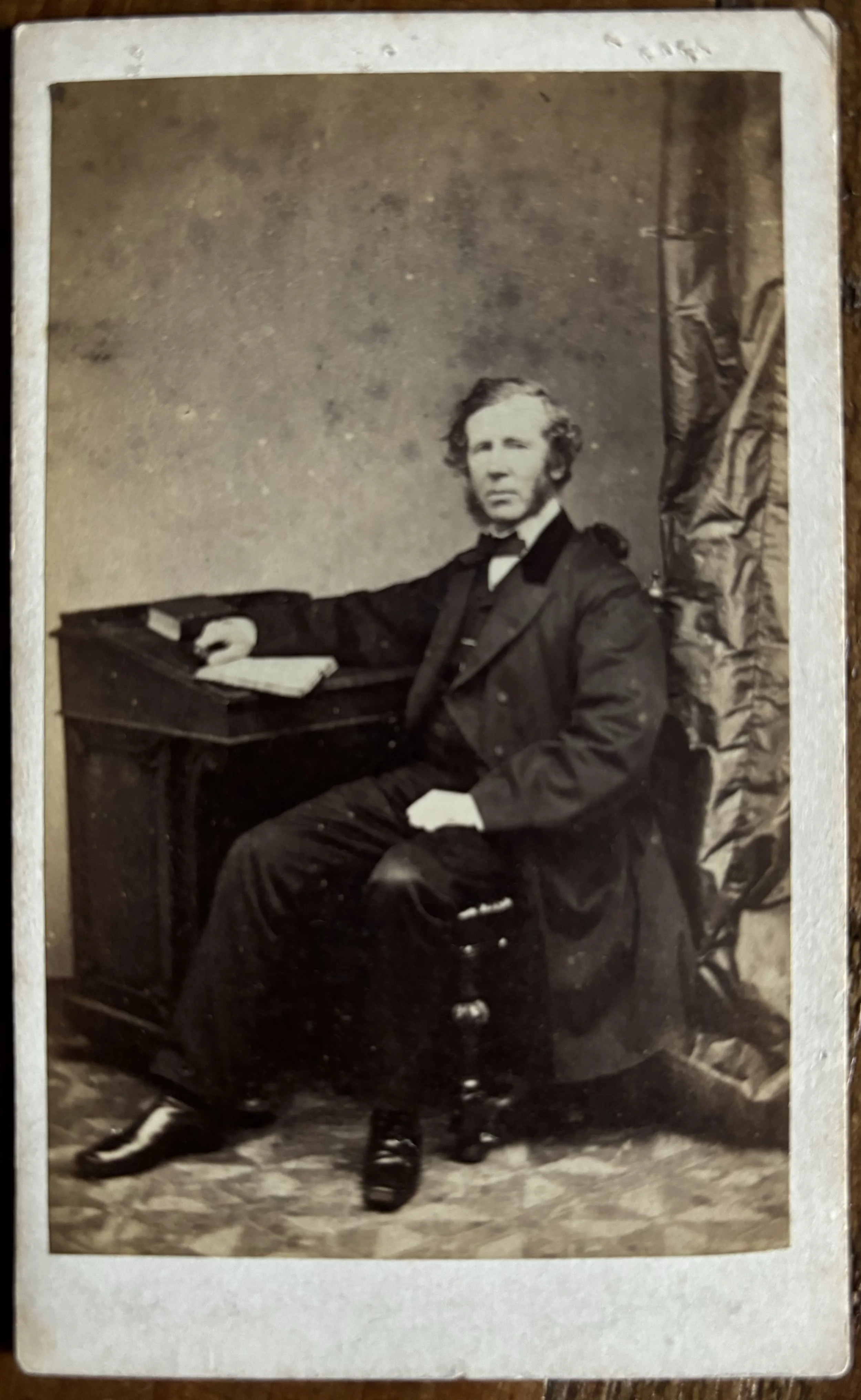 Carte de Visite portrait of a seated man in a frock coat by P P Skeolan, Leeds