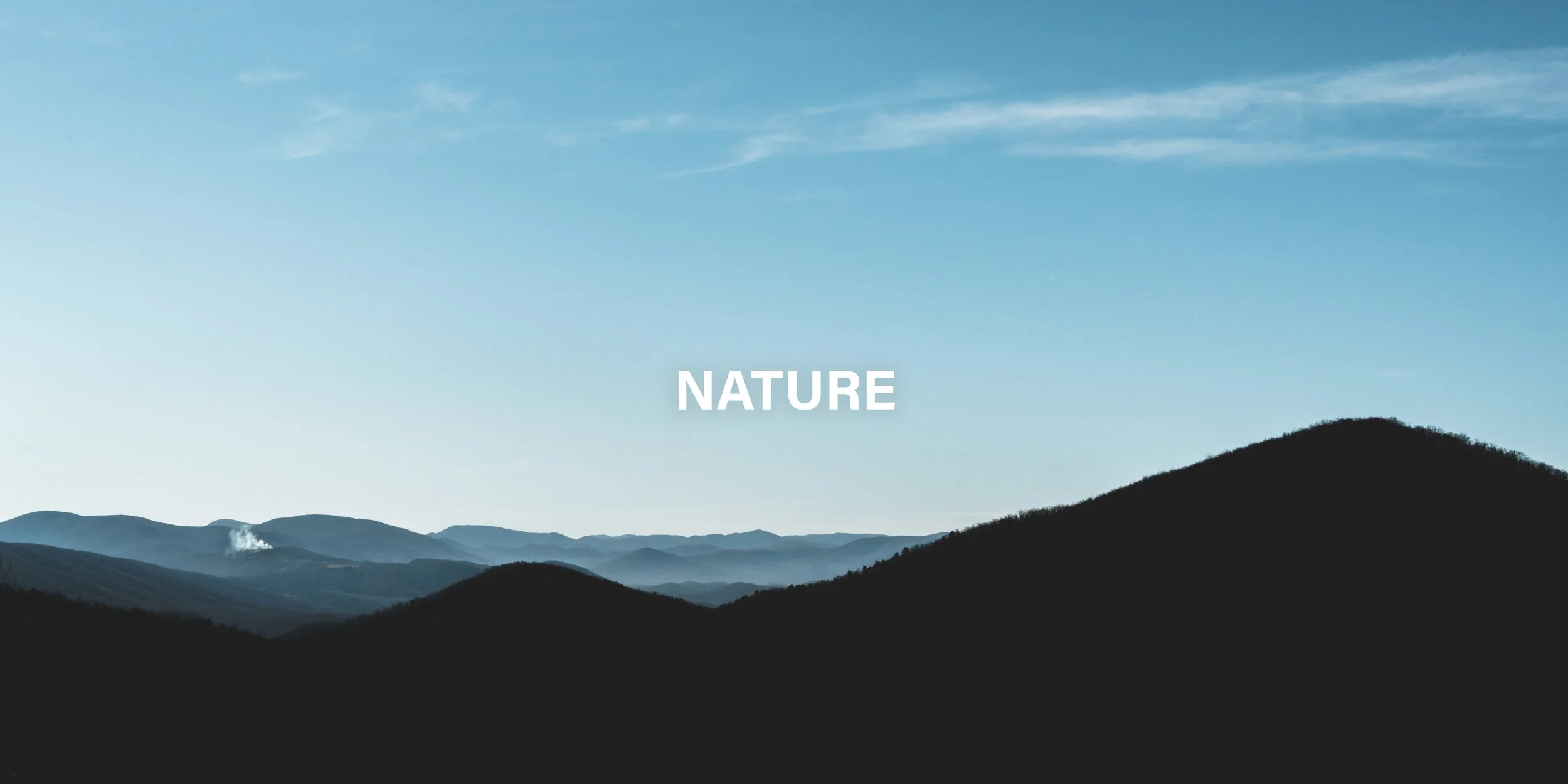 Scenic view of blue mountains with a clear sky