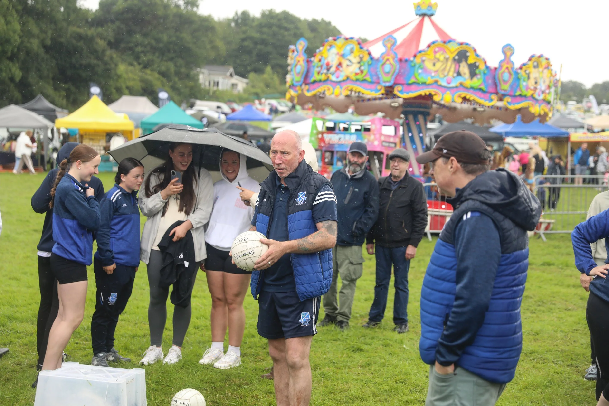 Man with football in carnival games area