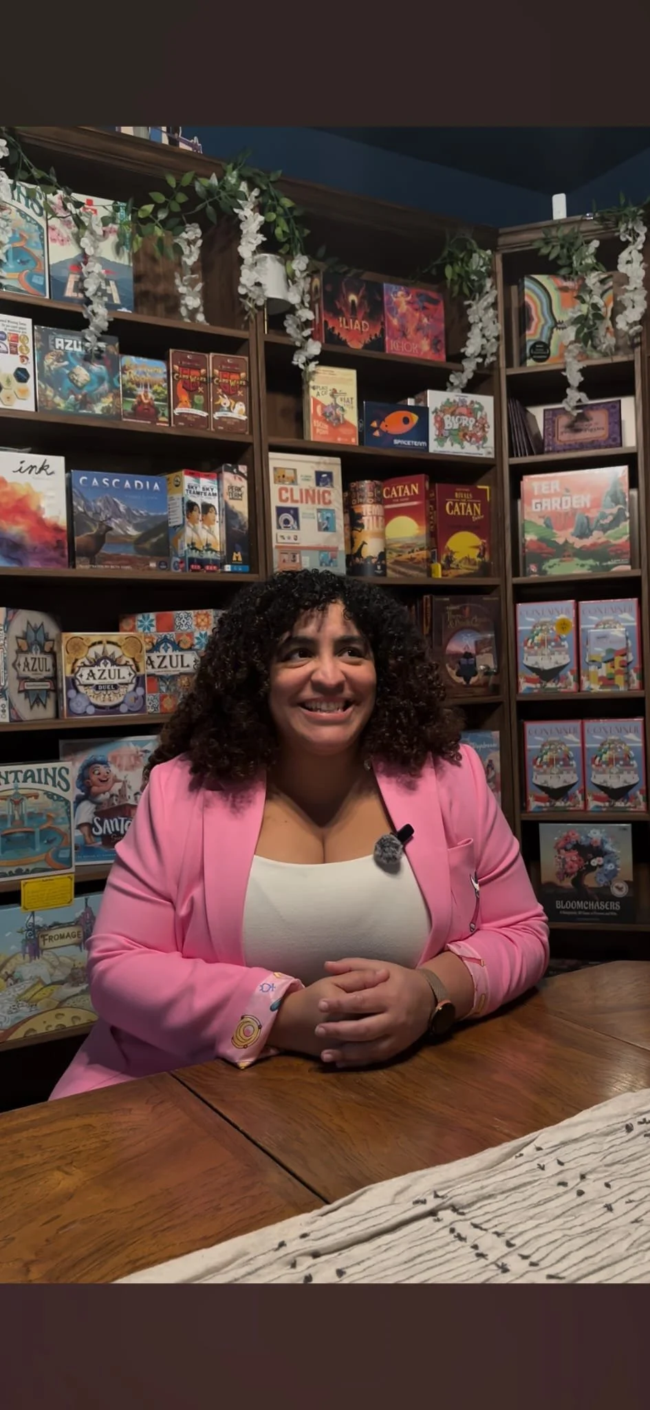 Dianna Lora (co-owner) sitting for an interview inside The Secret Lantern Books & Games