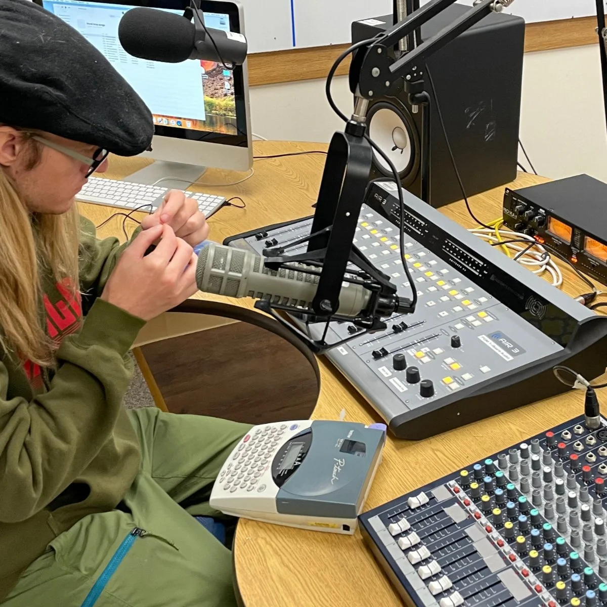 Engineer Dave Andersson surrounded by broadcast equipment.