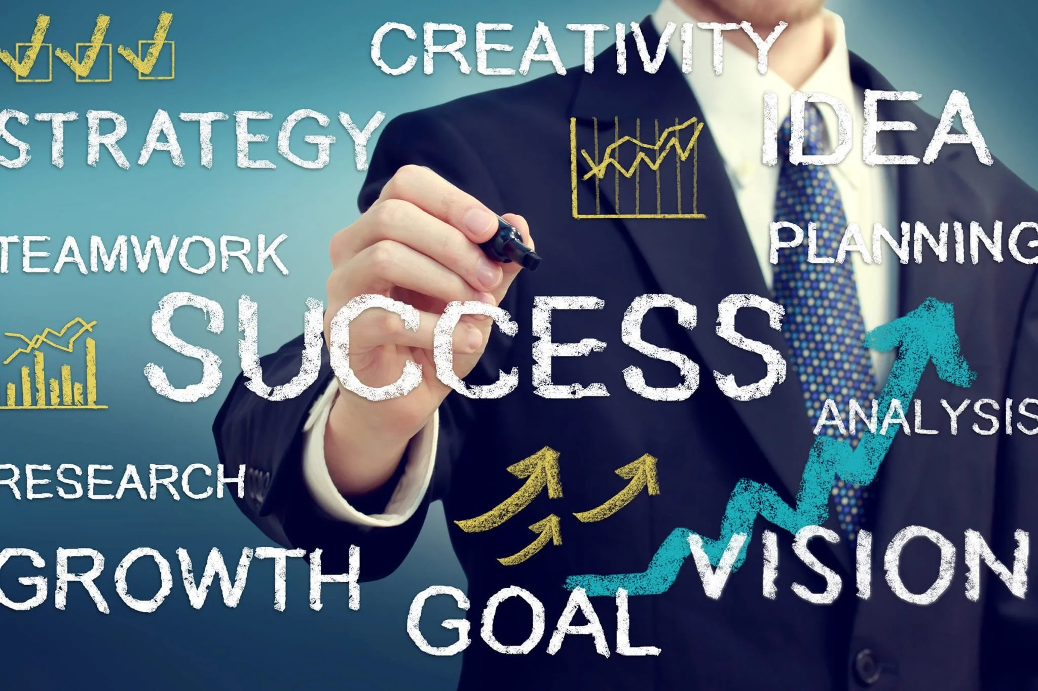 Businessperson in suit writing on transparent digital whiteboard with words like 'success,' 'creativity,' 'strategy,' 'teamwork,' 'research,' 'growth,' 'goal,' 'planning,' 'analysis,' 'vision,' and illustrations of upward trending graphs.