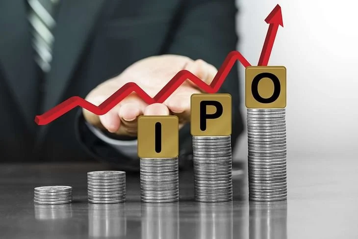 Stacks of coins with letter tiles spelling 'IPO' and an upward trending red graph line.