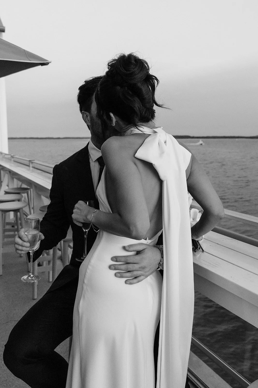 A bride and groom sharing a kiss at St George Sailing Club.