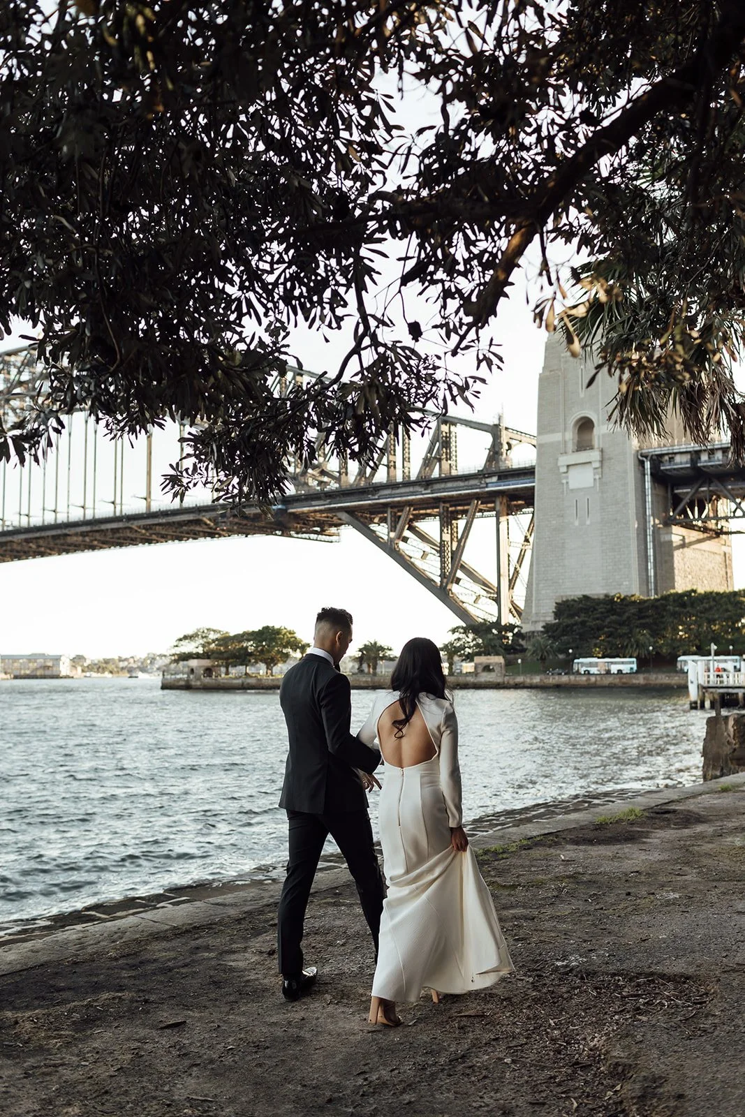 Bride and groom at Kirribili Lookout at sunset with the Sydney Harbour Bridge in the background