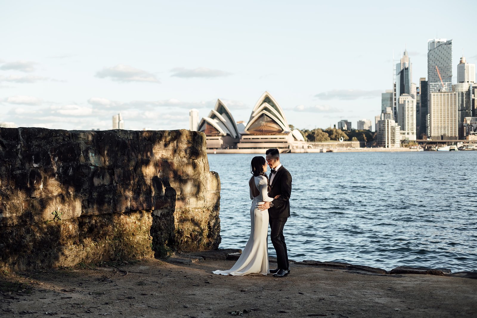Bride and groom at Kirribili Lookout at sunset with the Sydney Opera House in the background