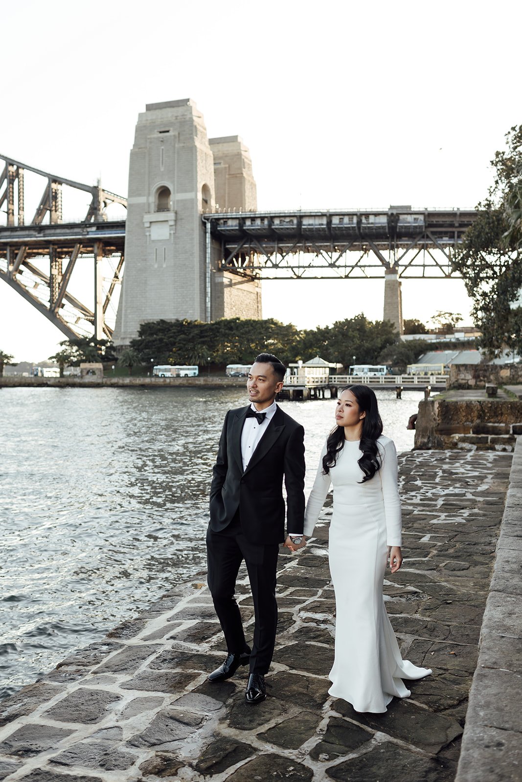 Bride and groom at Kirribili Lookout at sunset with the Sydney Harbour Bridge in the background