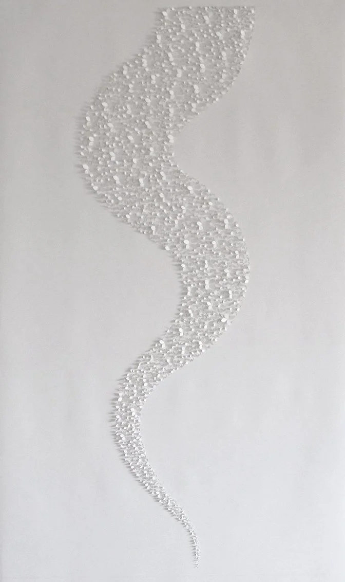 A handcut artwork on pristine white paper. Shaped in a cascading tail