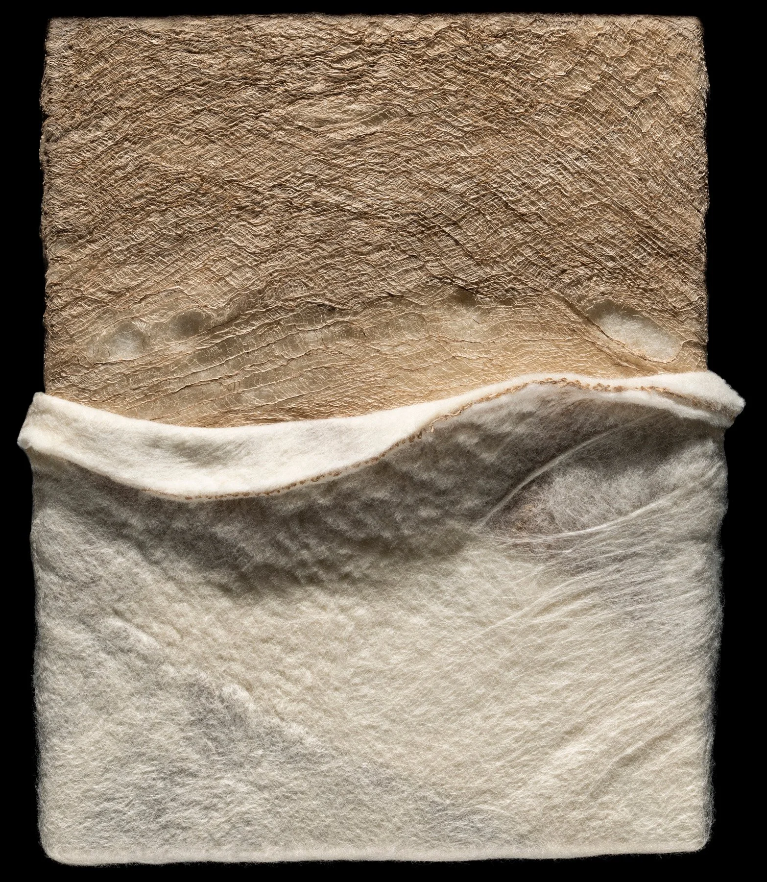 Close-up of a fabric face mask with a textured, beige outer layer and a soft, white inner lining.