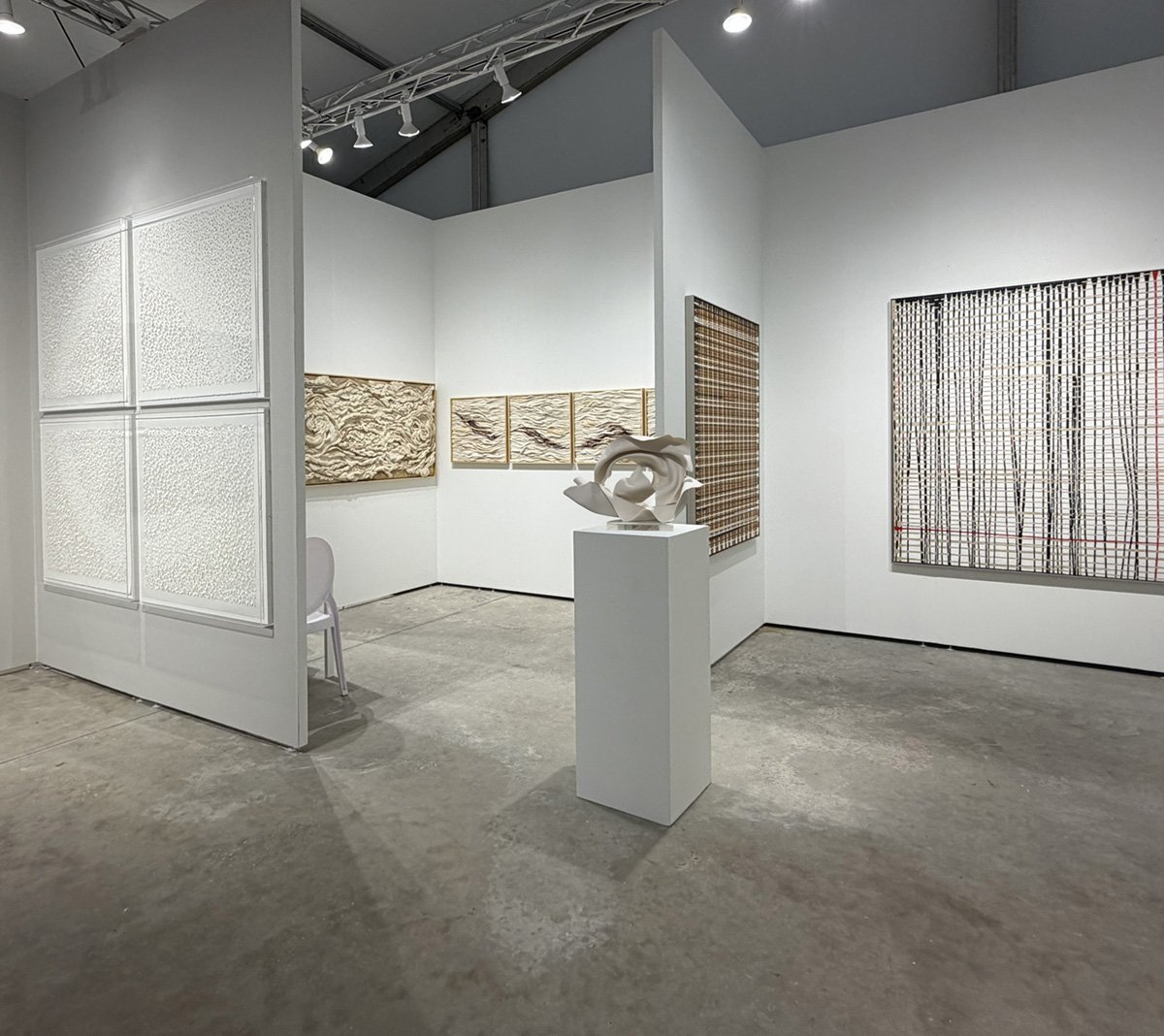 People walking and viewing artwork in an art gallery or exhibition space.