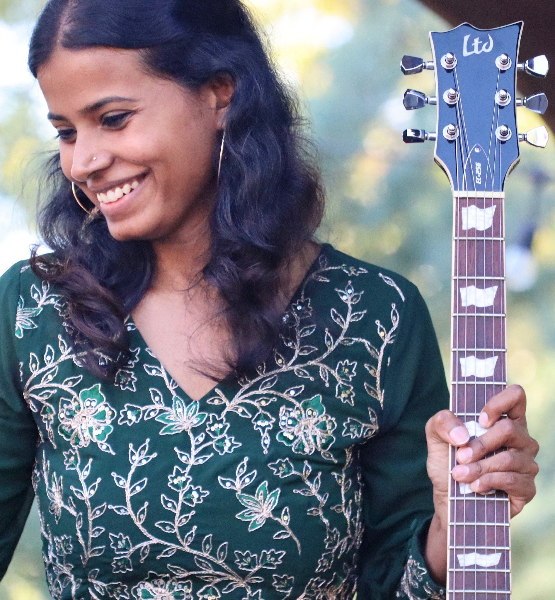 Adult woman playing guitar in Cornelius