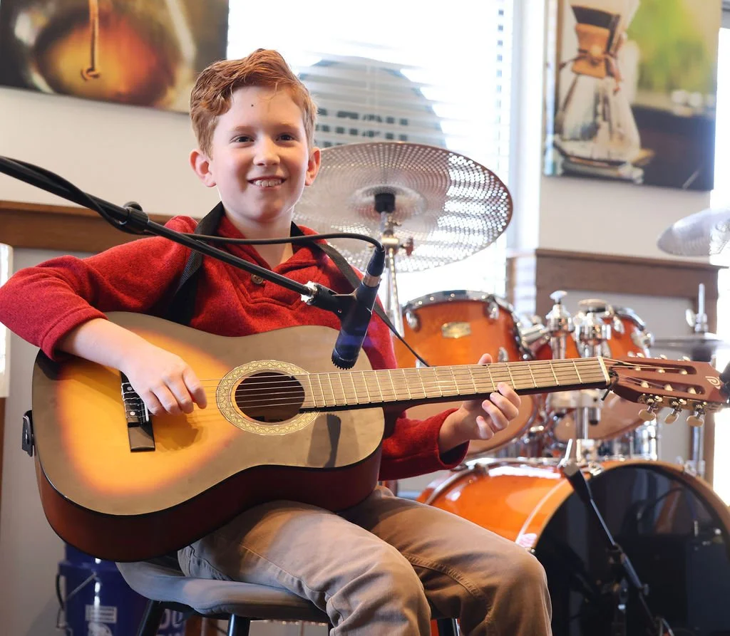 Student playing guitar during a private lesson at Learn Music serving the Lake Norman, NC area