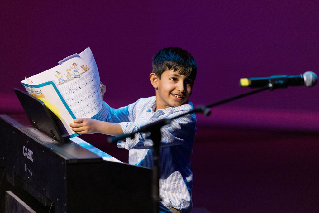 Student playing piano during a private lesson in Cornelius, NC