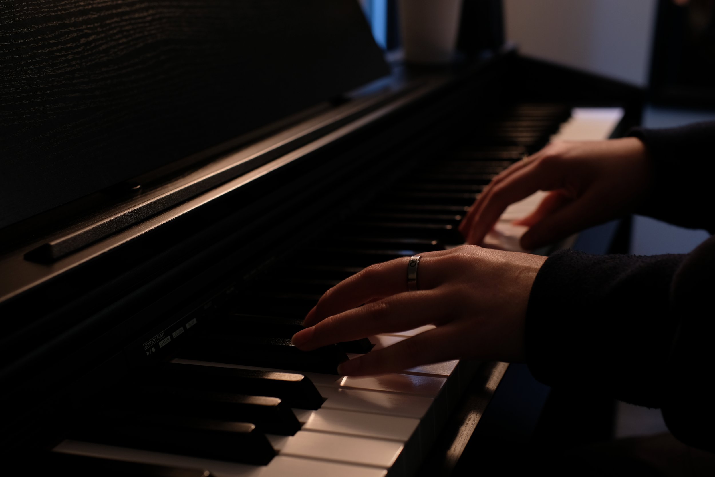 Adult student playing piano during a private lesson in Cornelius, NC