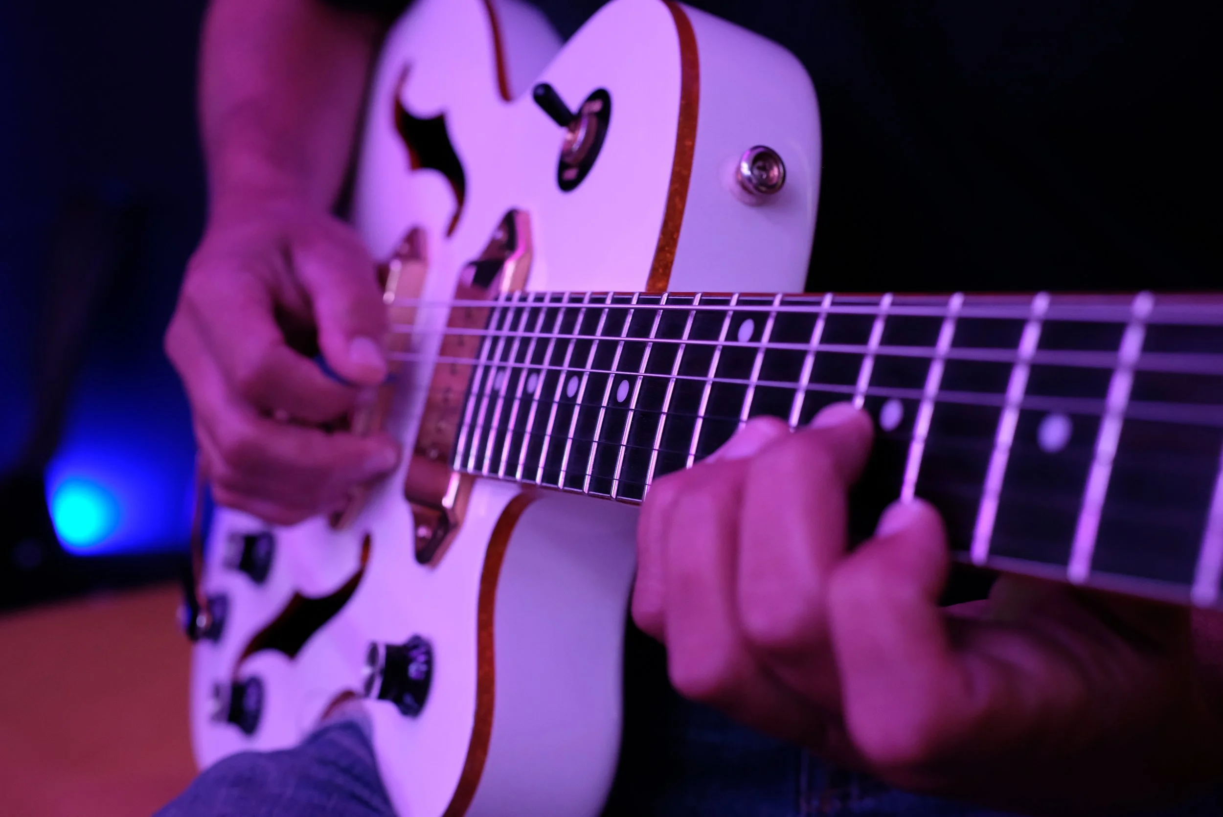 Adult student playing guitar during a private lesson near Davidson, NC