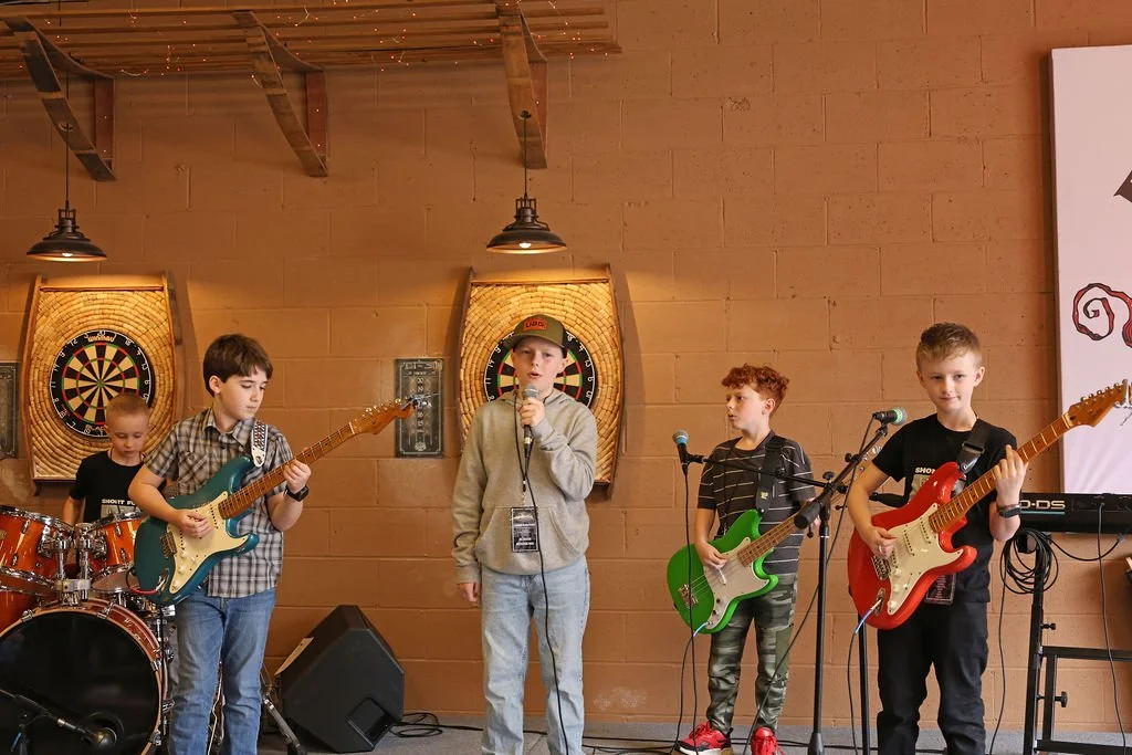 A group of young boys playing in a band
