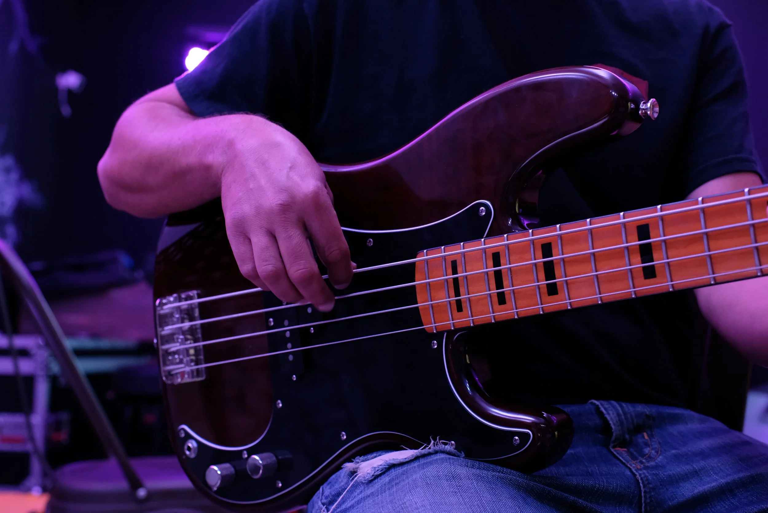 Adult student playing bass guitar during a private lesson in Davidson, NC