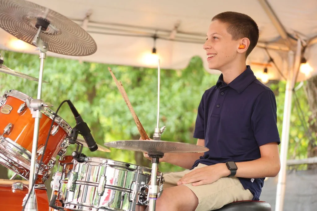 Student drummer performing at a Legends Showcase rock band event in Huntersville, NC