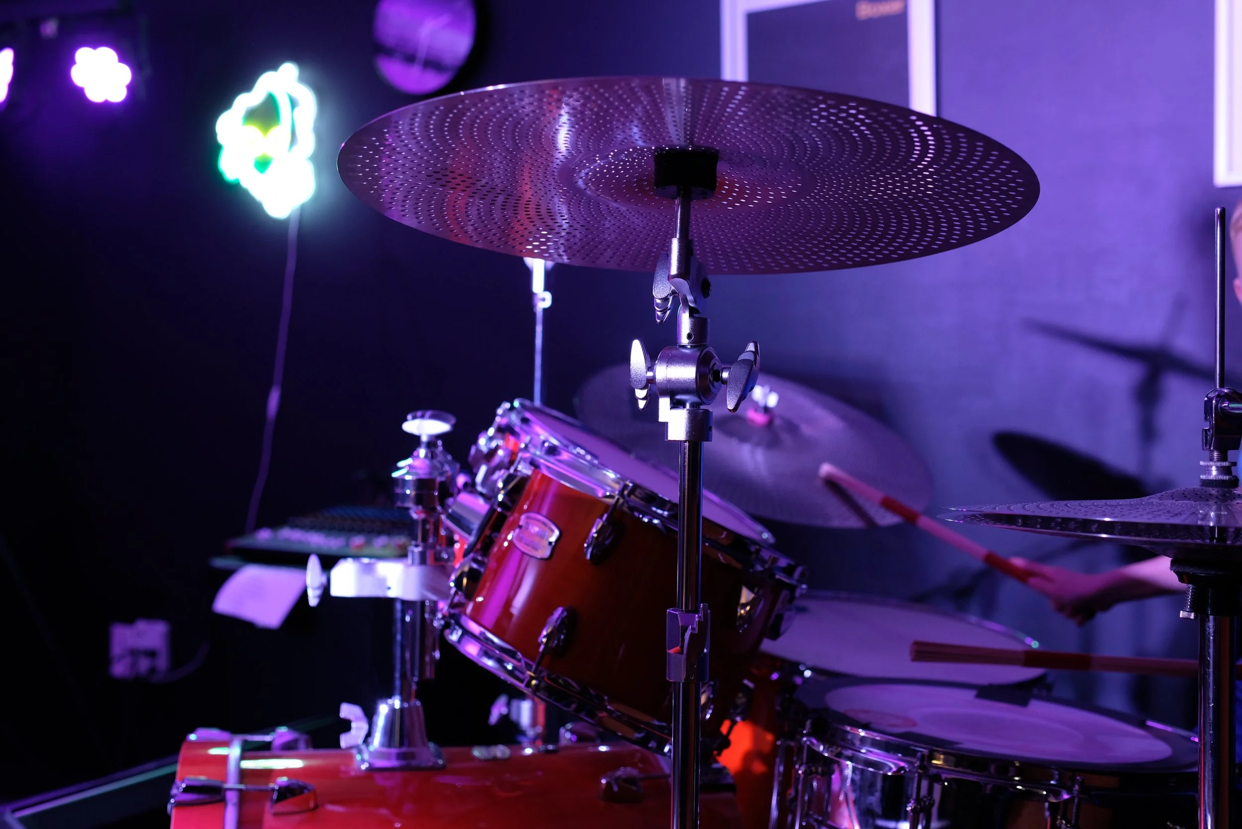 Adult student playing drums during a private lesson in Davidson, NC