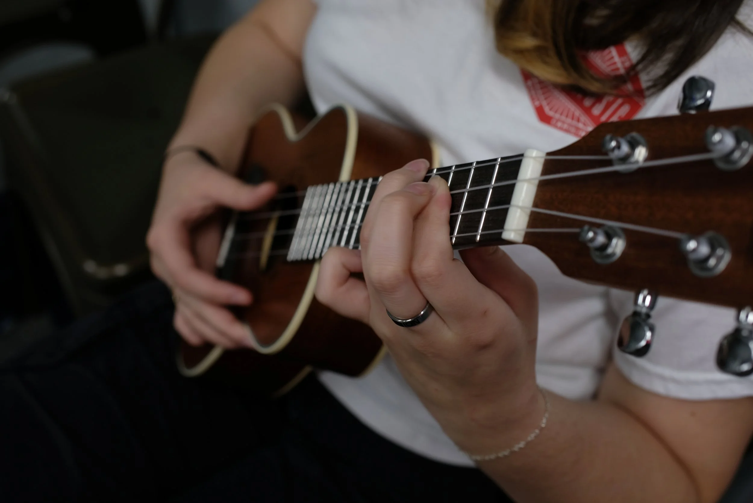 Adult student playing ukulele during a private lesson near Davidson, NC