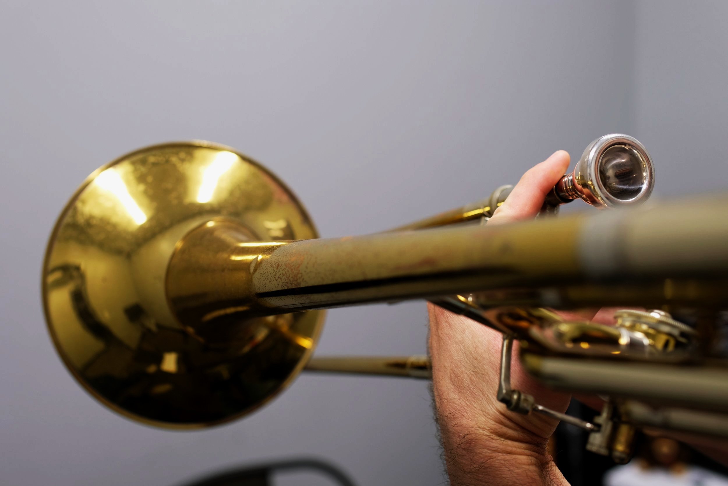 Adult student playing trombone during a private lesson in Cornelius, NC
