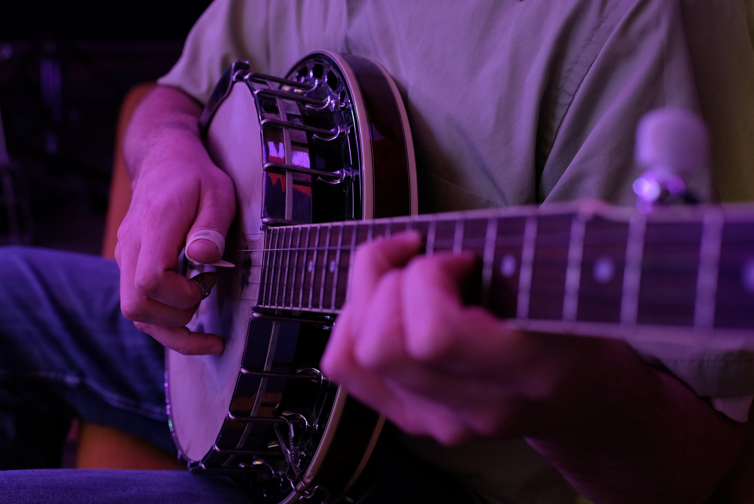 Adult student playing banjo during a private lesson in Davidson, NC