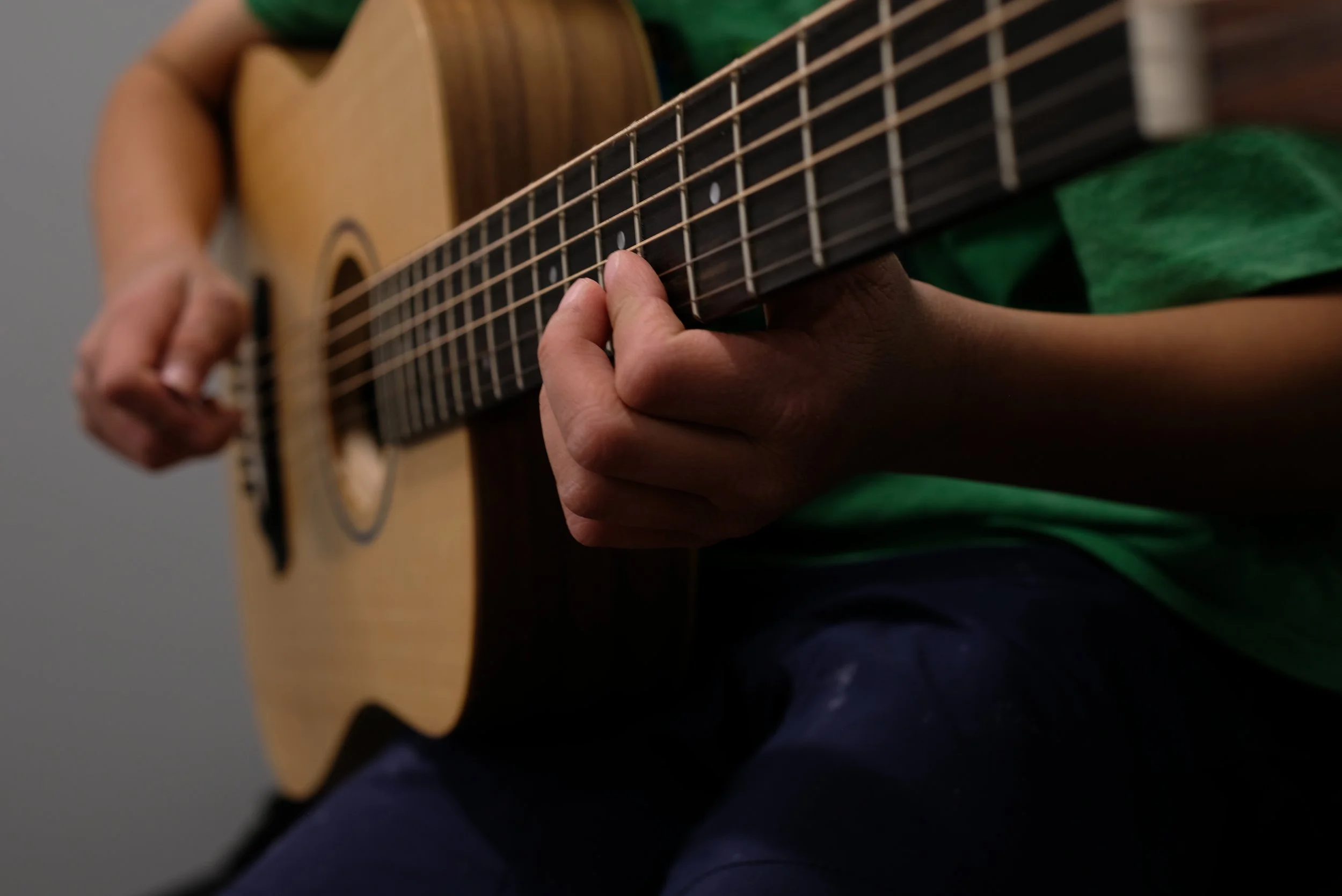 Student playing guitar during a private lesson in Cornelius, NC