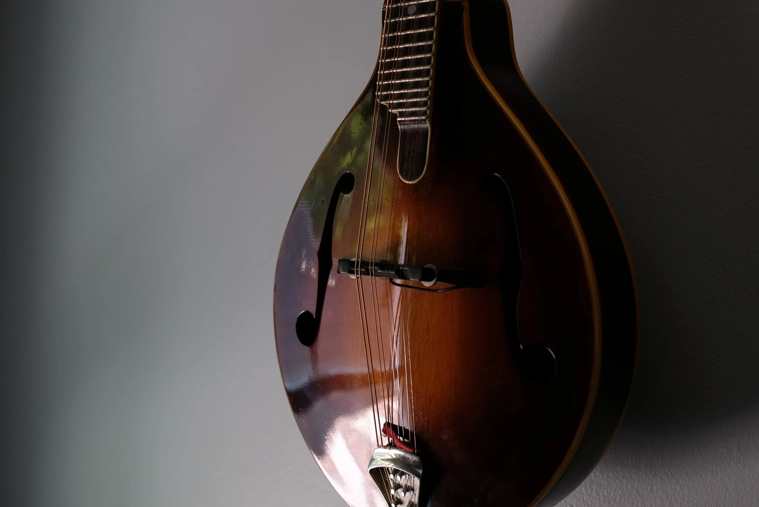 Adult student playing mandolin during a private lesson in Davidson, NC
