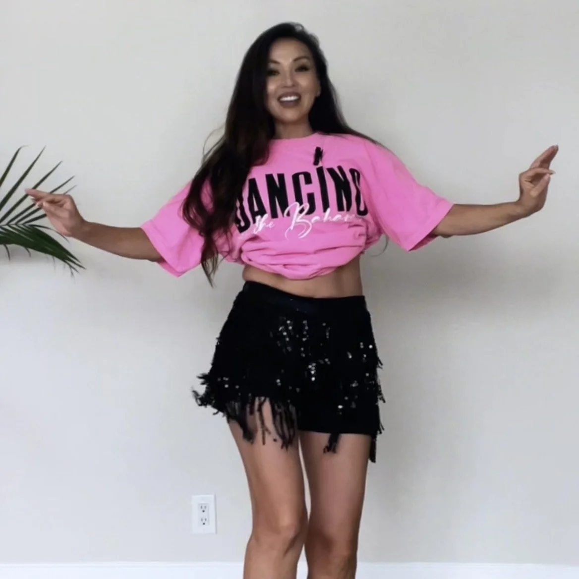 Uyanga, founder of Belly Heat, mid-dance pose demonstrating confident, playful movement