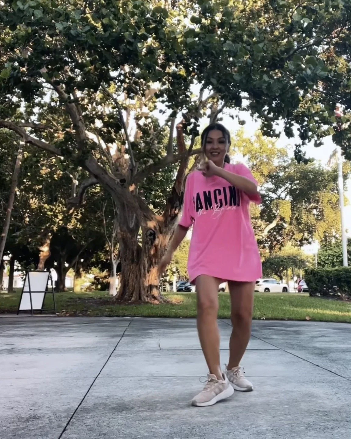 Woman doing a dance cardio move outdoors at George English Park, demonstrating belly dance and Afro-Caribbean-based cardio in Fort Lauderdale