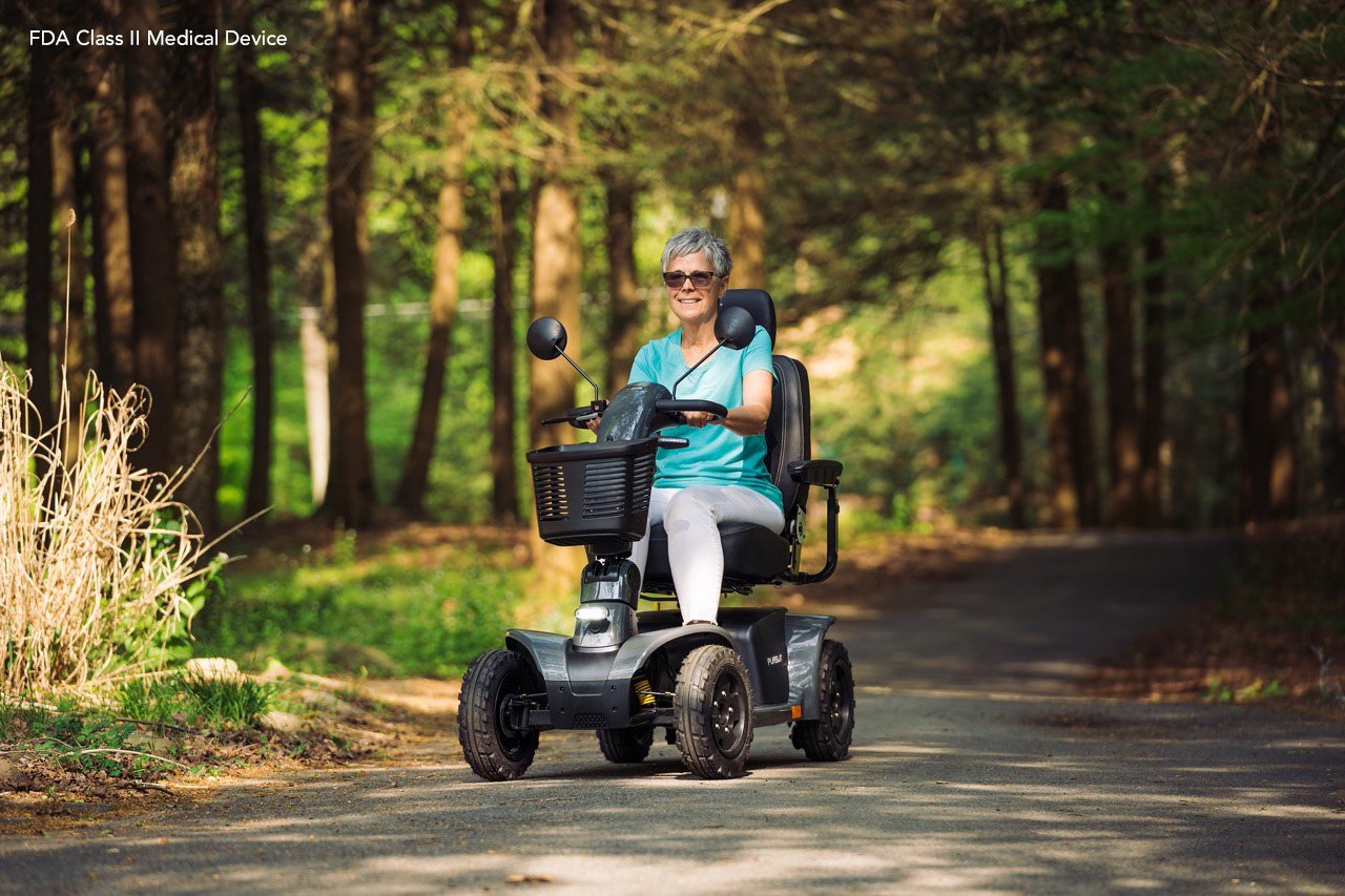 Image of a pride pursuit 2 mobility scooter out for an afternoon walk