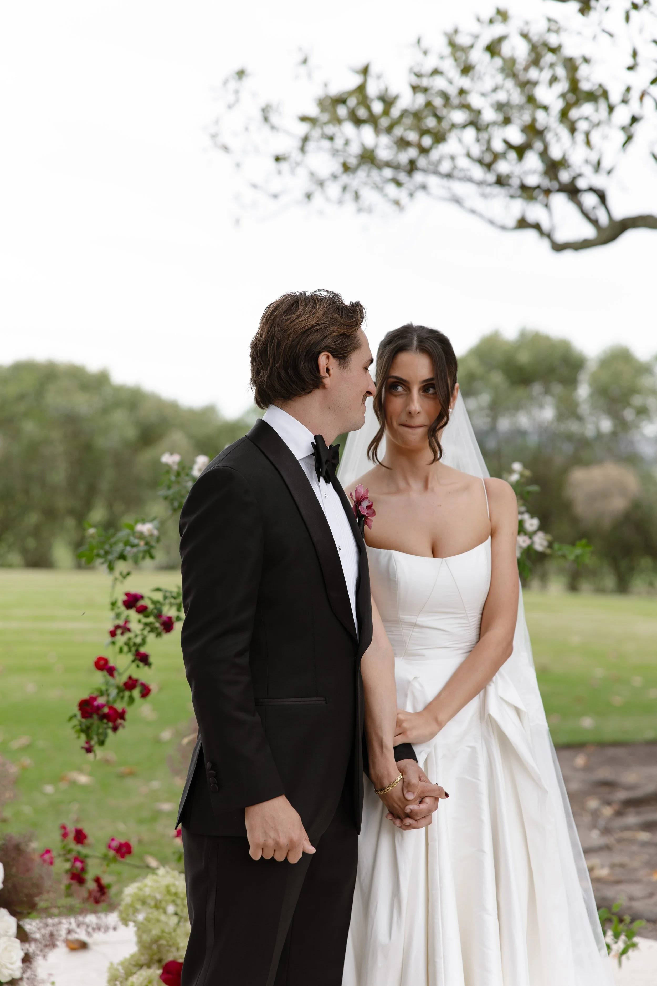 A bride and groom holding hands during wedding ceremony at Hunter Valley wedding venue Wallalong House.