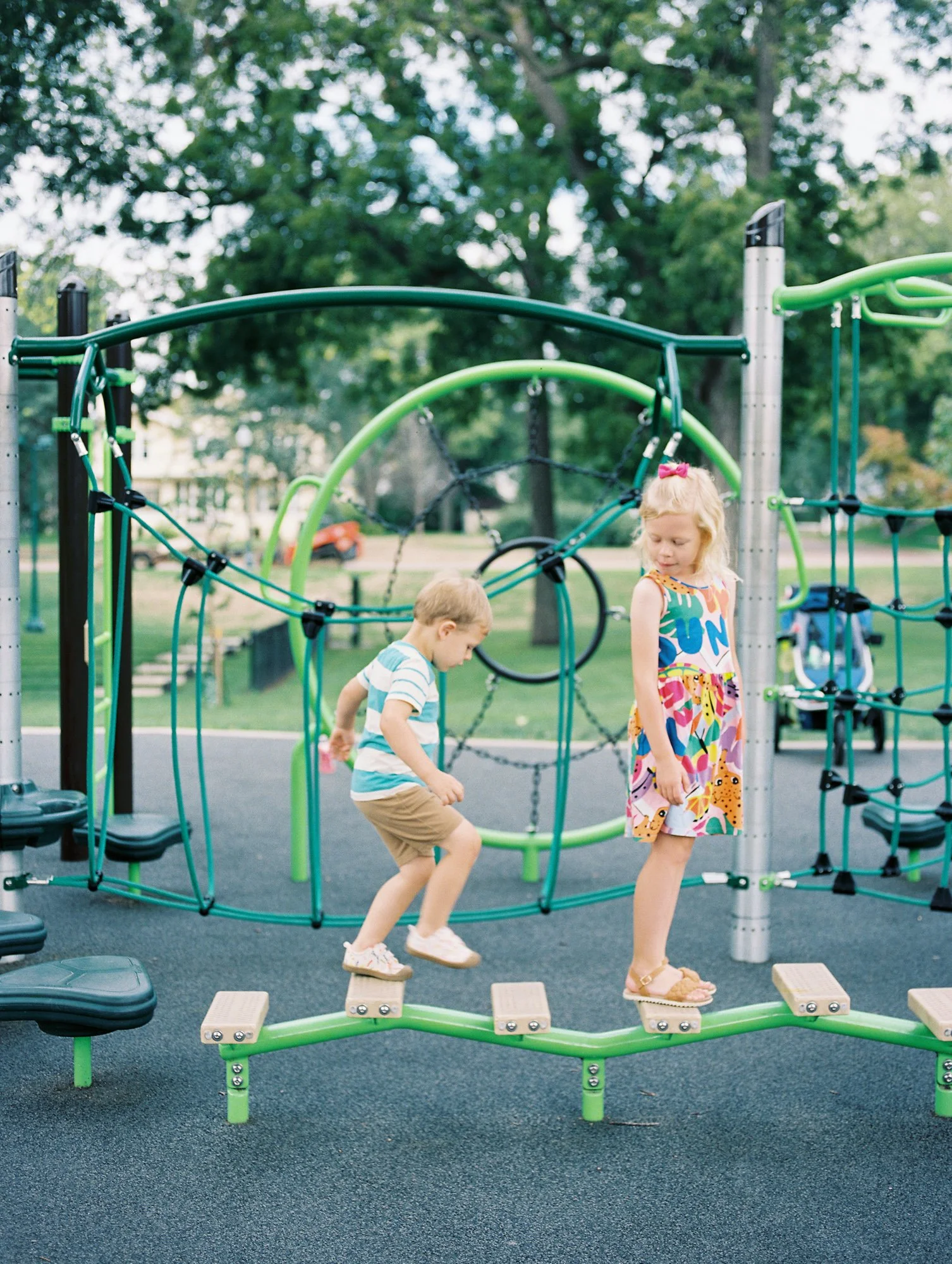 Two children playing at a park in McKennan Park Sioux Falls.
