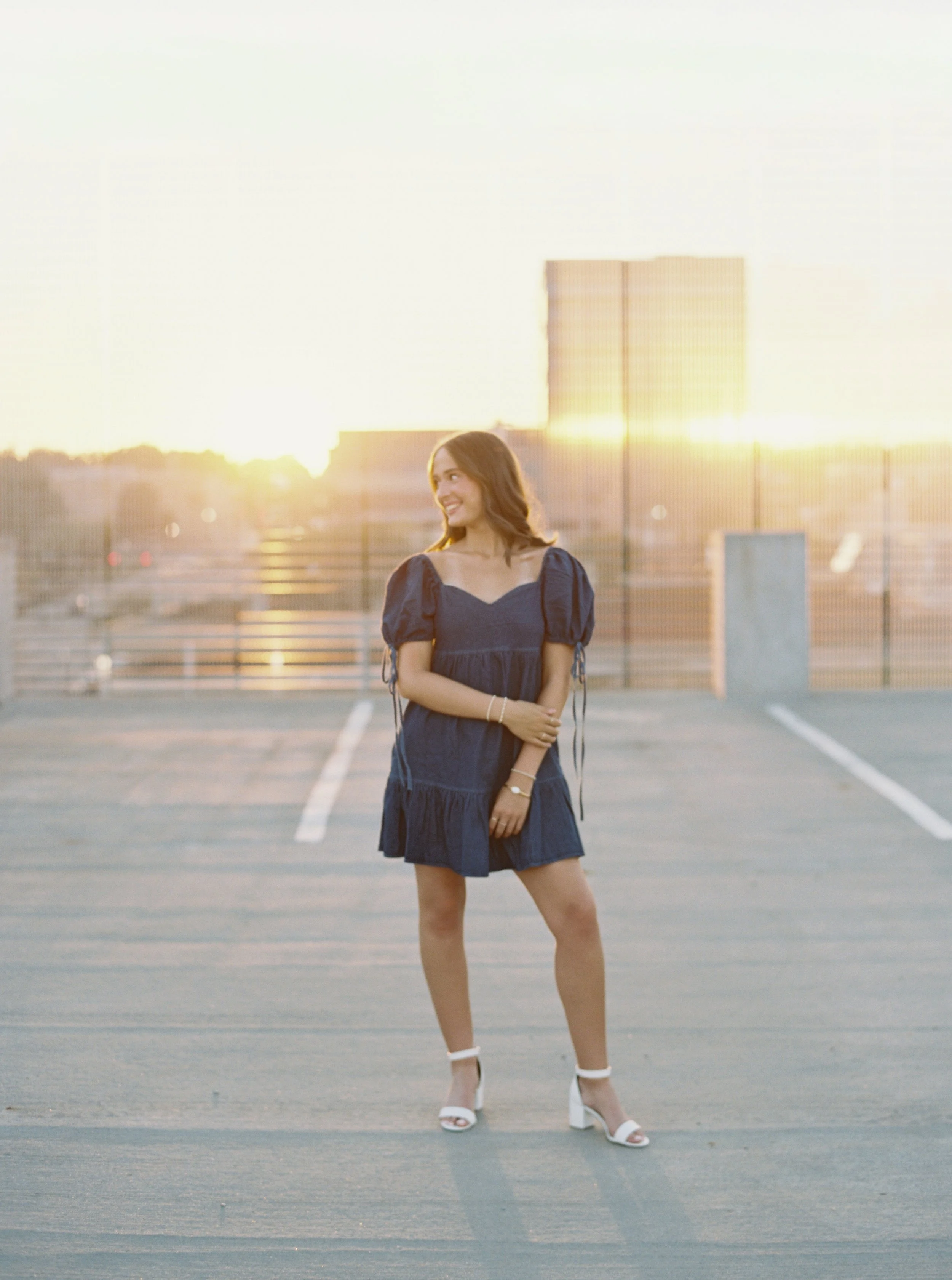Artistic senior portrait with playful energy and soft film texture